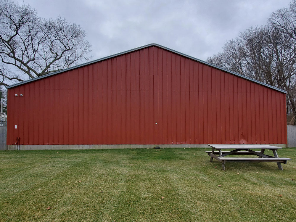 Picture of metal barn prior to the painting of the Giant Cows Mural by The Art Of Life