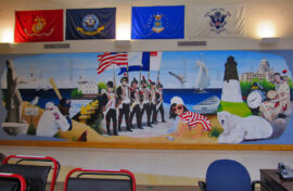 Celebrate Rhode Island's vibrant history and culture with this stunning 30-foot mural! From the iconic Newport Bridge to the beloved PawSox, this artwork captures the essence of the Ocean State. Created for the VA Medical Center in Providence, this mural is a testament to the state's rich heritage and a source of pride for Rhode Islanders. Discover the details and stories woven into this captivating piece!